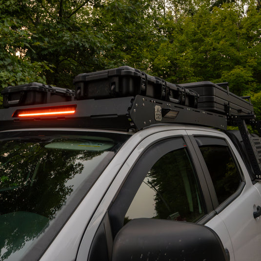 Ford Ranger with roof rack and lights in a forest setting